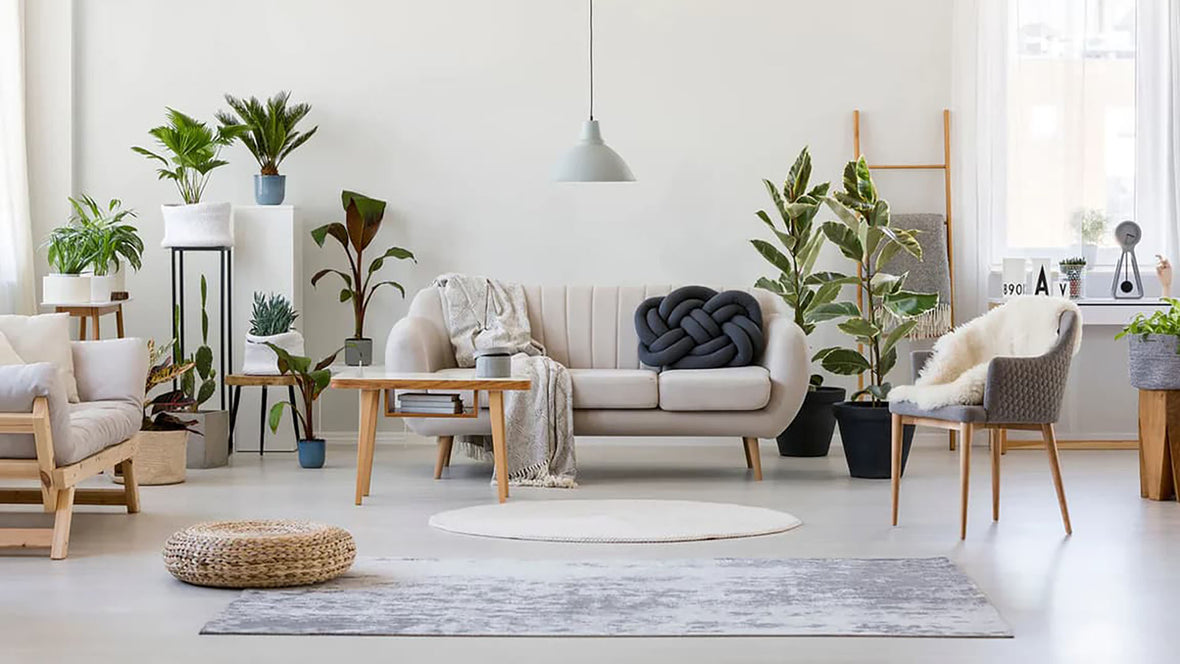 A cozy living room filled with plans and a hanging chandelier shade as an accent piece
