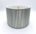 A celadon silk string short drum lampshade with vertical string texture and internal gold metal frame, shown against a plain white background.