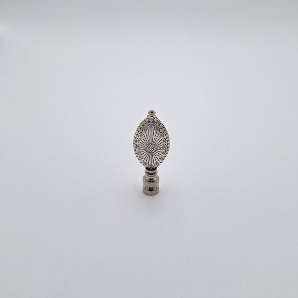 An engraved oval finial with an antiqued nickel finish and detailed engraved patterns, shown against a plain white background.
