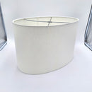A bone linen retro oval lampshade with rolled edges and a translucent finish, shown against a plain white background.