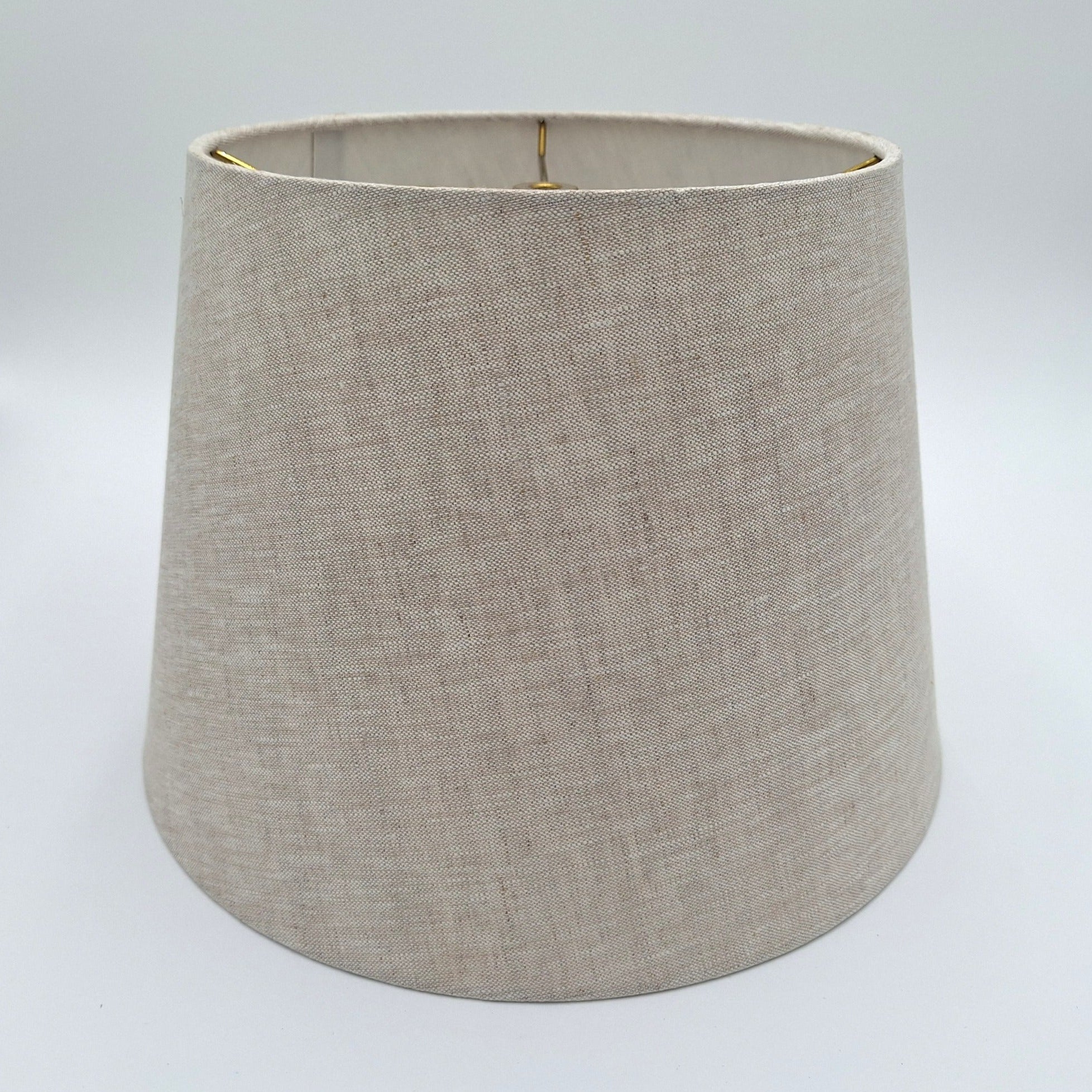 A natural linen British Empire lampshade with rolled edges and translucent finish, shown against a plain white background.