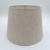 A natural linen British Empire lampshade with rolled edges and translucent finish, shown against a plain white background.