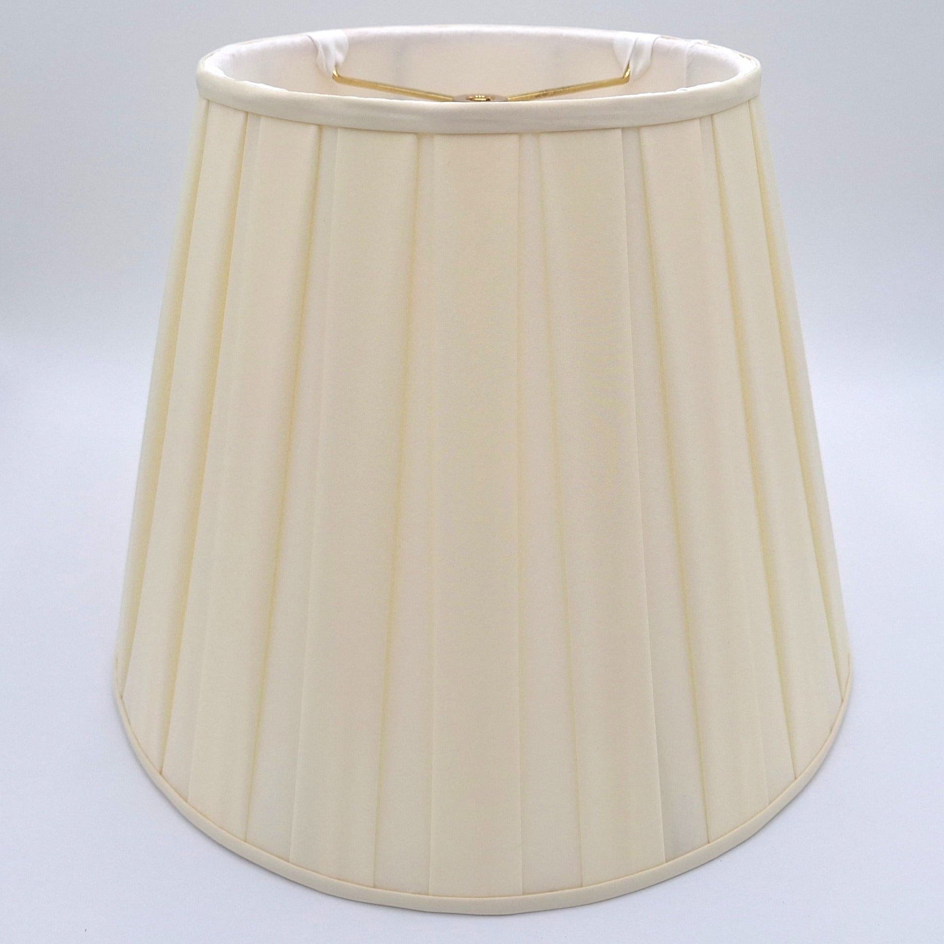 A beige pongee space box pleat empire lampshade shown at a slight angle, highlighting the distinctive spaced pleat design.