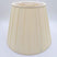 A beige pongee space box pleat empire lampshade shown at a slight angle, highlighting the distinctive spaced pleat design.