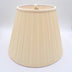 An eggshell shantung space box pleat empire lampshade shown at a slight angle, highlighting the distinctive spaced pleat pattern.